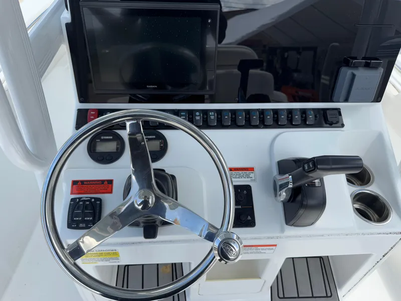 Slide: The Image of 2021 Sea Hunt Ultra 219 boat dashboard with steering wheel and controls. - 34