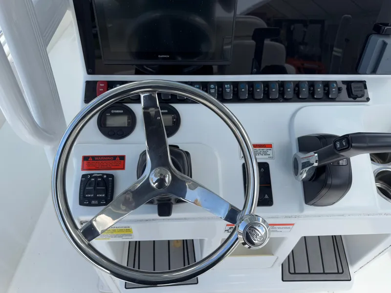 Slide: The Image of Steering console of 2021 Sea Hunt Ultra 219 boat with controls and display. - 35