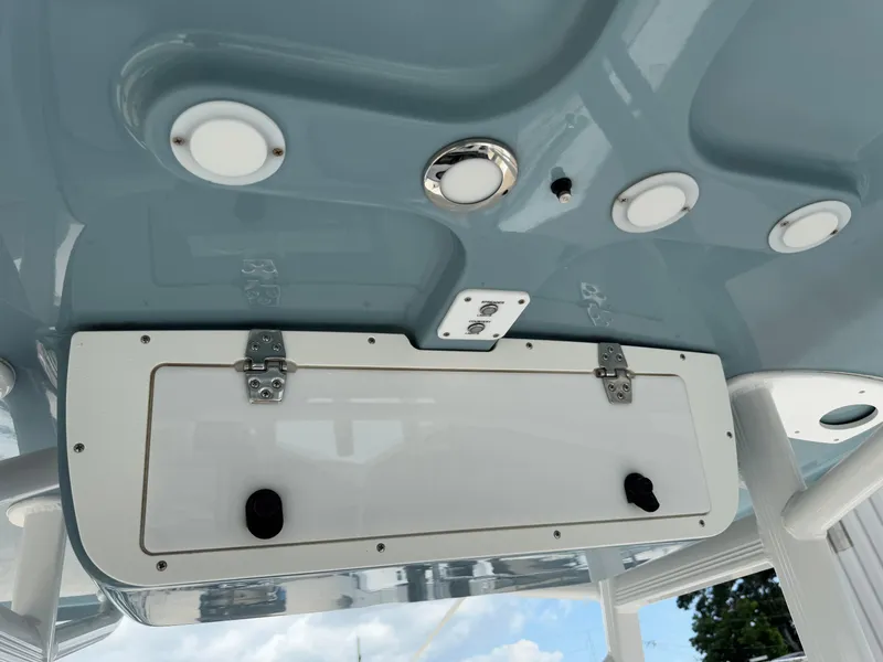 Slide: The Image of 2021 Sea Hunt Ultra 219 boat ceiling with lights and storage compartment. - 38