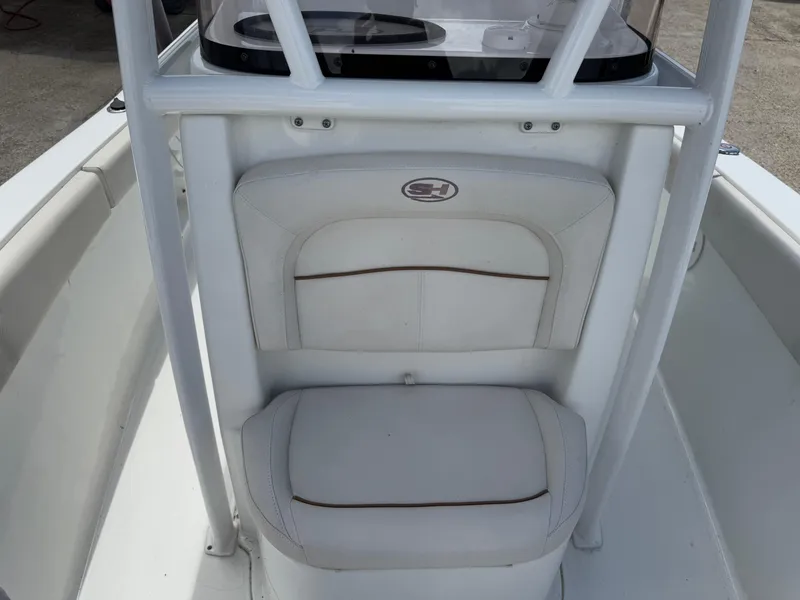 Slide: The Image of 2021 Sea Hunt Ultra 219 boat interior with white cushioned seating. - 39