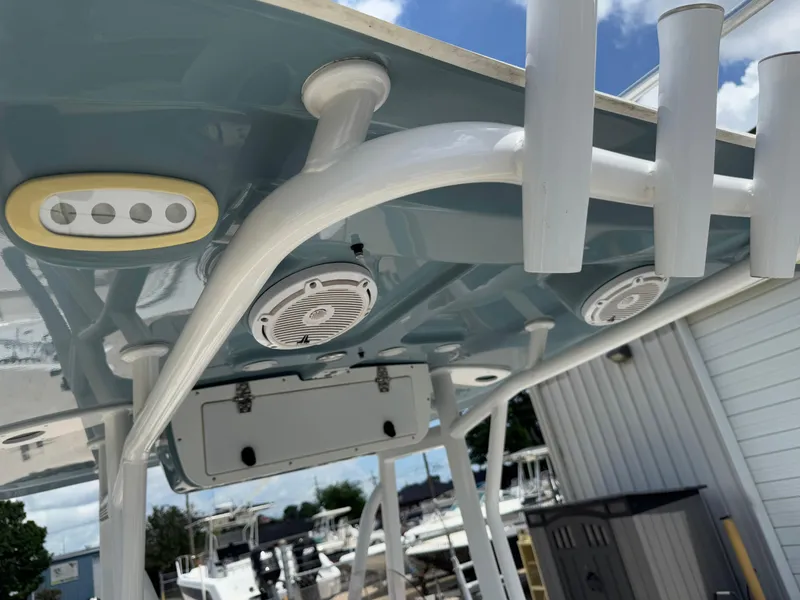 Slide: The Image of 2021 Sea Hunt Ultra 219 boat T-top with speakers and rod holders. - 41