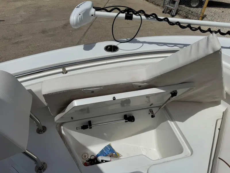 Slide: The Image of 2021 Sea Hunt Ultra 219 boat with open storage compartment and trolling motor. - 43