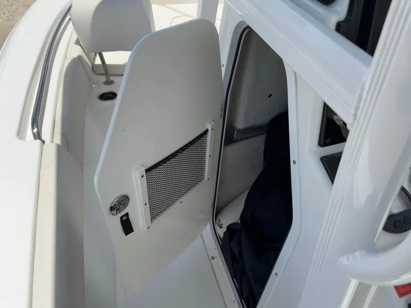 Slide: The Image of 2021 Sea Hunt Ultra 219 boat interior with open storage compartment. - 47