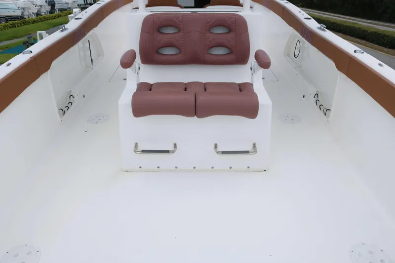 Slide: The Image of 2022 Twin Vee 340 GFX boat interior with brown seating and white deck. - 11