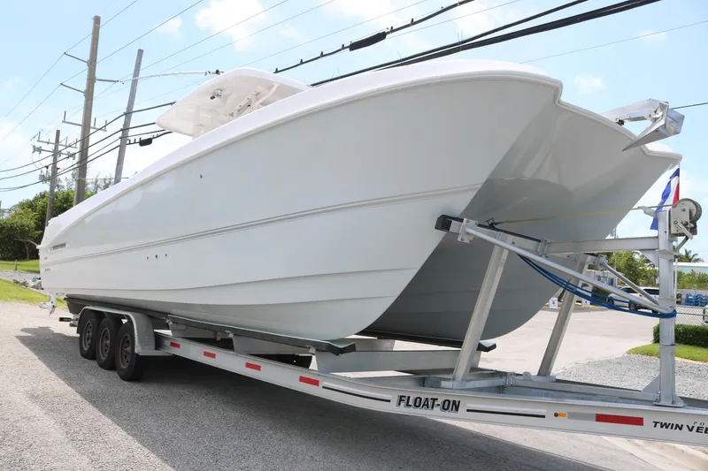 Slide: The Image of 2022 Twin Vee 340 GFX boat on trailer, side view, outdoors. - 2