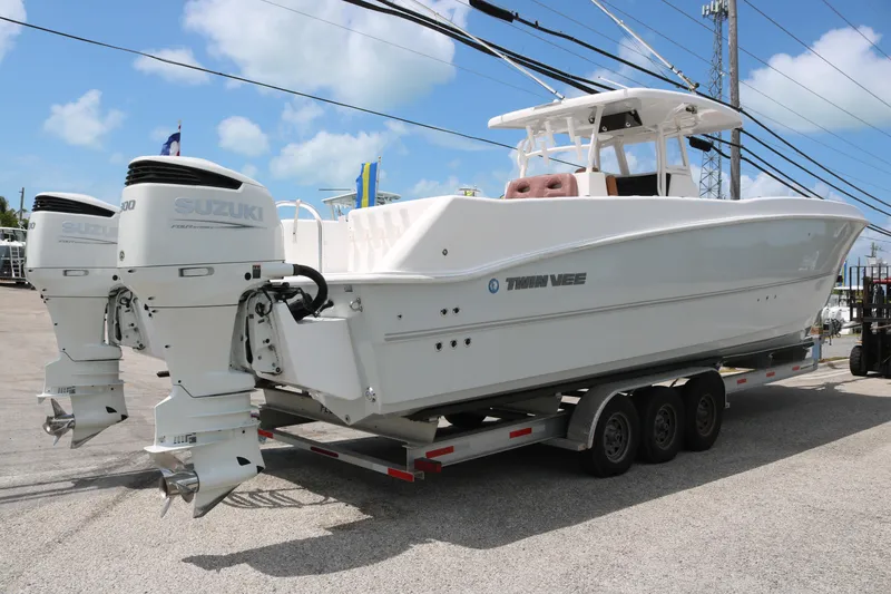 Slide: The Image of 2022 Twin Vee 340 GFX boat on trailer with dual Suzuki outboard engines. - 3