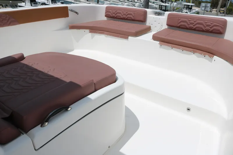 Slide: The Image of 2022 Twin Vee 340 GFX boat interior with brown cushioned seating. - 8