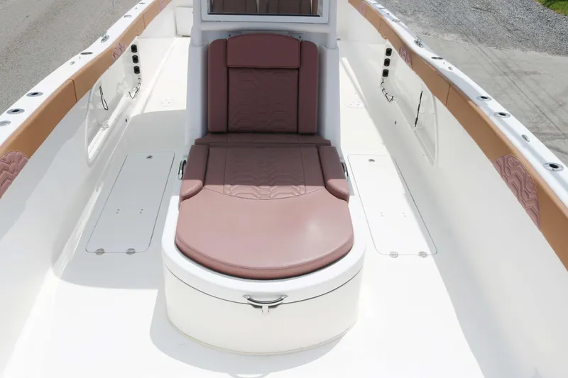 Slide: The Image of 2022 Twin Vee 340 GFX boat interior with cushioned seating and storage compartments. - 9
