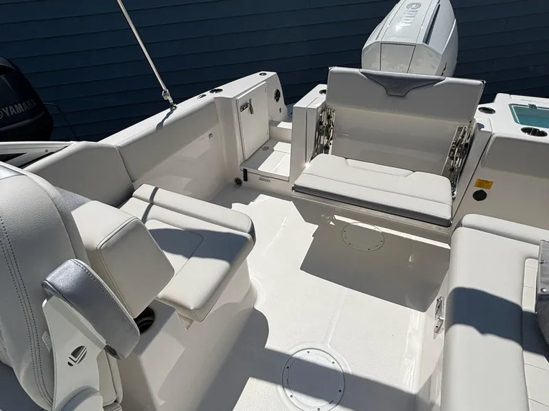 Slide: The Image of 2026 Sailfish 236 DC boat interior with seating and Yamaha engine. - 12