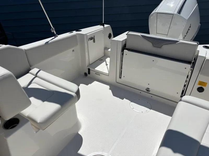 Slide: The Image of 2026 Sailfish 236 DC boat interior with seating and engine view. - 13