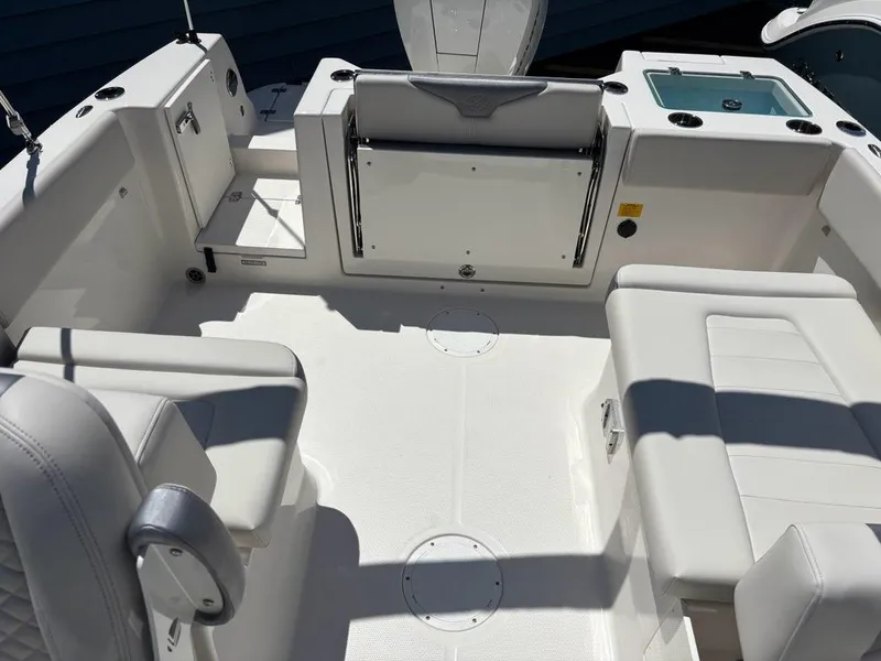 Slide: The Image of 2026 Sailfish 236 DC boat interior with white seating and storage compartments. - 14