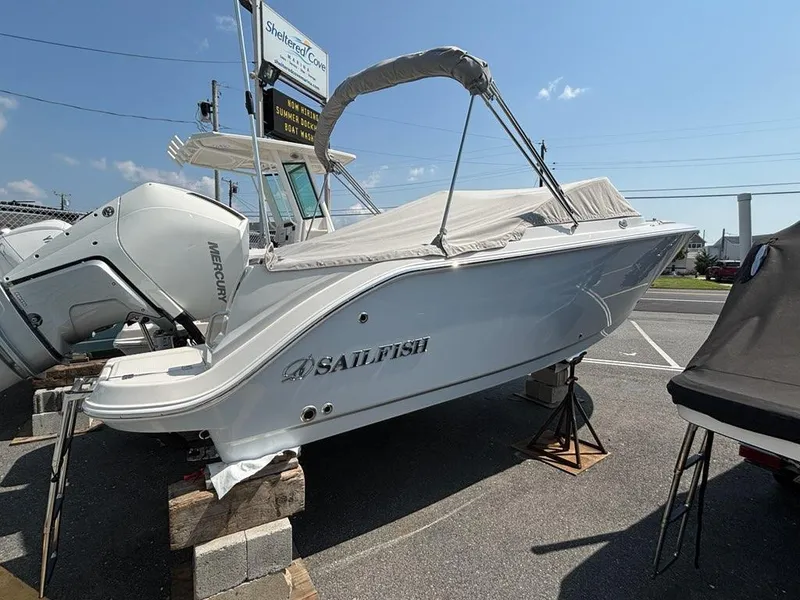 Slide: The Image of 2026 Sailfish 236 DC boat on display, covered and elevated, with Mercury engine visible. - 3