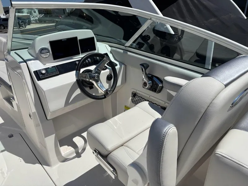 Slide: The Image of 2026 Sailfish 236 DC boat cockpit with modern steering and controls. - 8