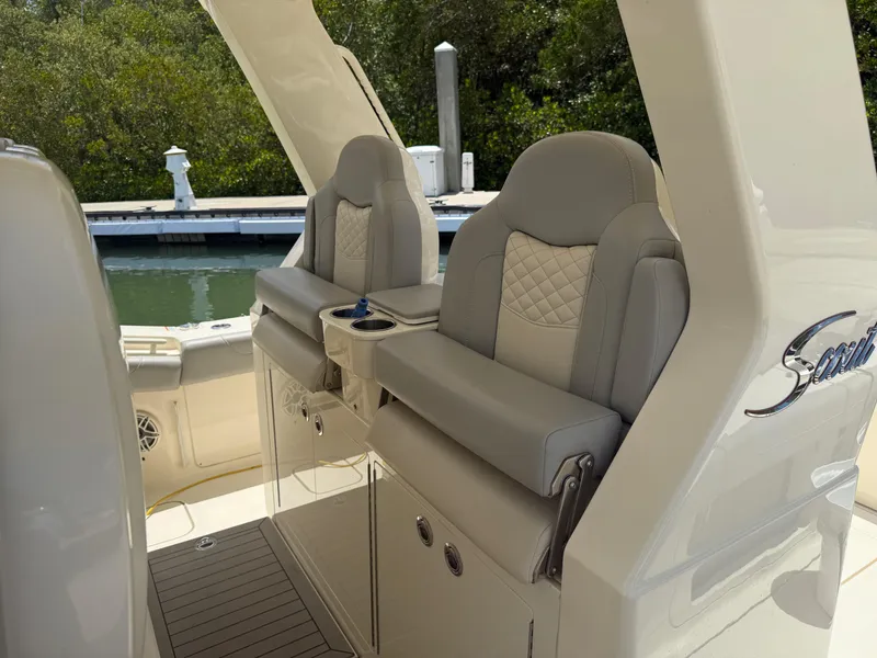 Slide: The Image of 2022 Scout 425 LXF boat seats with elegant design and waterfront view. - 14