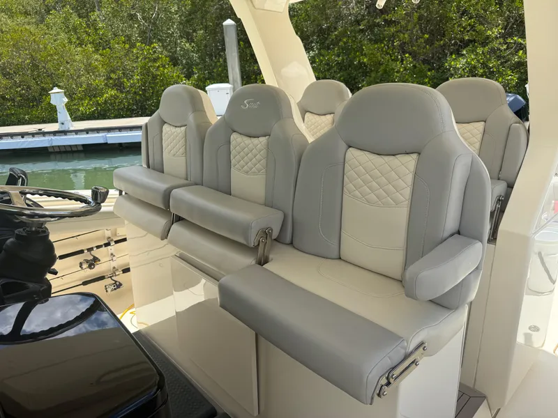 Slide: The Image of Luxurious seating on 2022 Scout 425 LXF boat, featuring elegant gray upholstery. - 16
