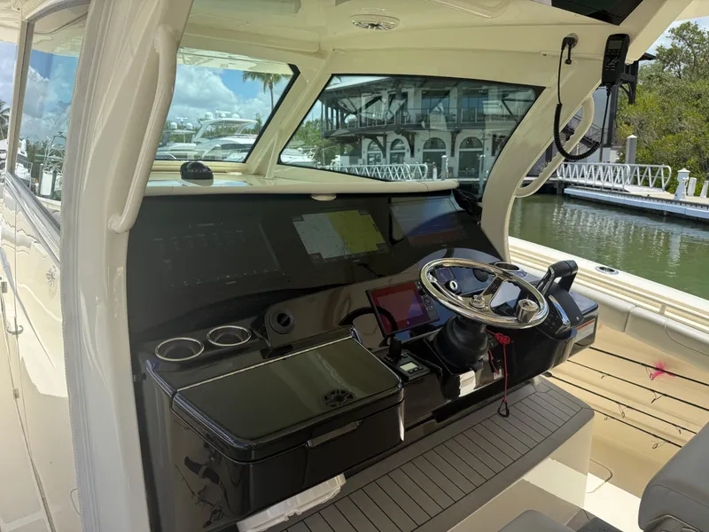 Slide: The Image of 2022 Scout 425 LXF boat cockpit with modern controls and steering wheel. - 17