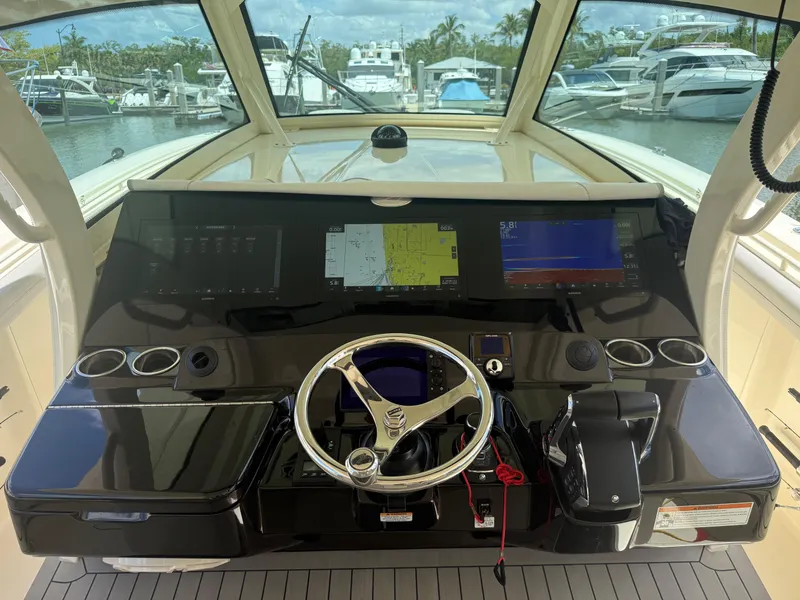 Slide: The Image of Helm of 2022 Scout 425 LXF boat with advanced navigation displays and steering wheel. - 19