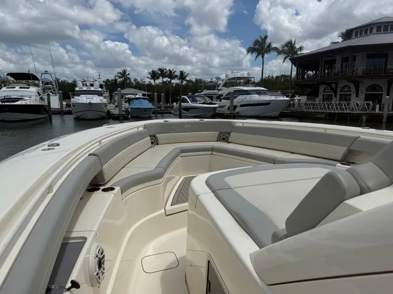 Slide: The Image of Luxurious 2022 Scout 425 LXF boat interior at marina with yachts and palm trees. - 22