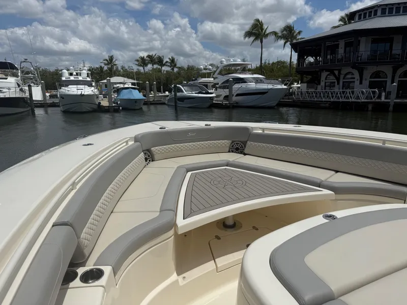 Slide: The Image of 2022 Scout 425 LXF boat interior at marina with yachts and palm trees. - 24