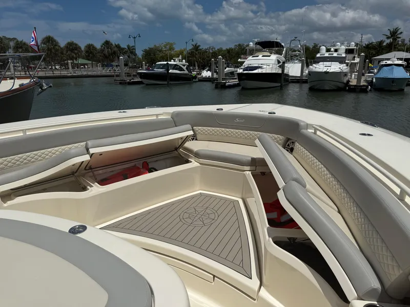 Slide: The Image of Luxurious 2022 Scout 425 LXF boat interior at marina, featuring elegant seating and spacious deck. - 26