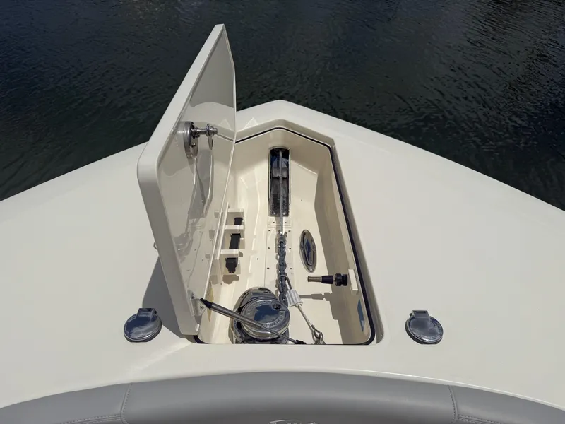 Slide: The Image of 2022 Scout 425 LXF boat anchor compartment with open hatch, showcasing marine equipment. - 27