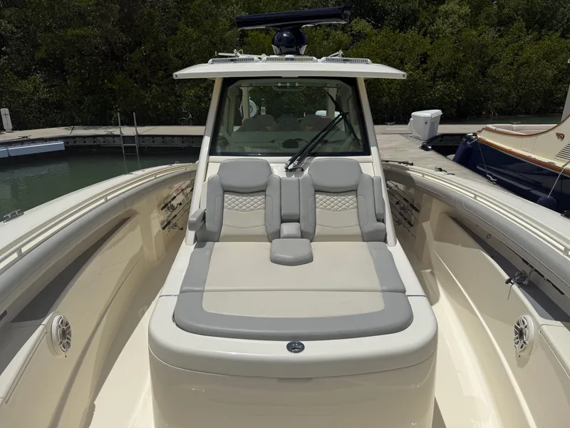 Slide: The Image of 2022 Scout 425 LXF boat with luxurious seating and sleek design. - 28