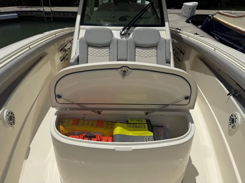 Slide: The Image of 2022 Scout 425 LXF boat with open storage compartment, revealing safety equipment. - 29