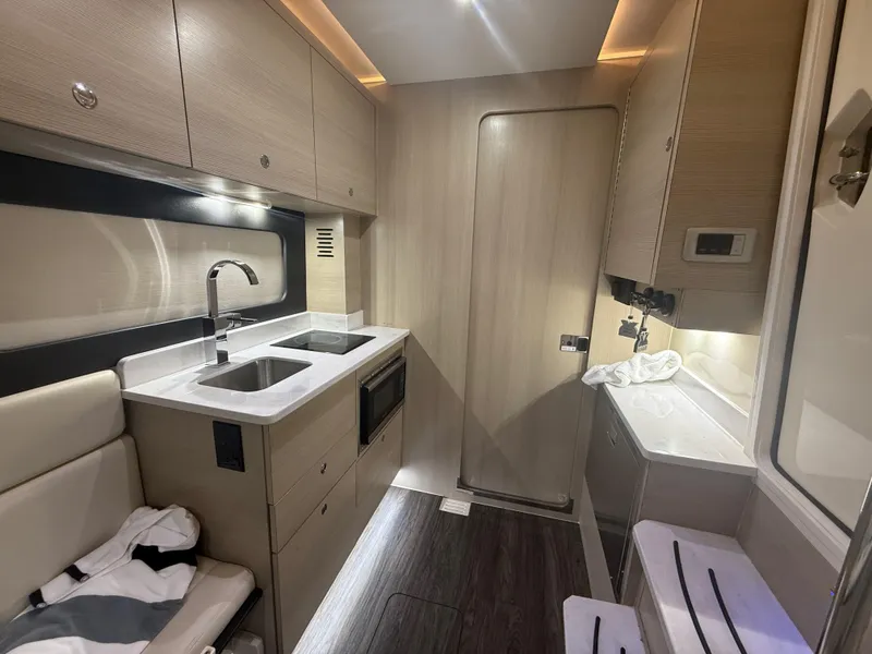 Slide: The Image of Luxurious interior of 2022 Scout 425 LXF boat featuring modern kitchen amenities. - 31