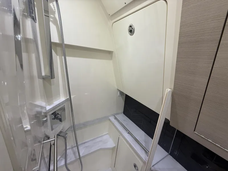 Slide: The Image of Interior of 2022 Scout 425 LXF boat, featuring sleek bathroom design with modern fixtures. - 34