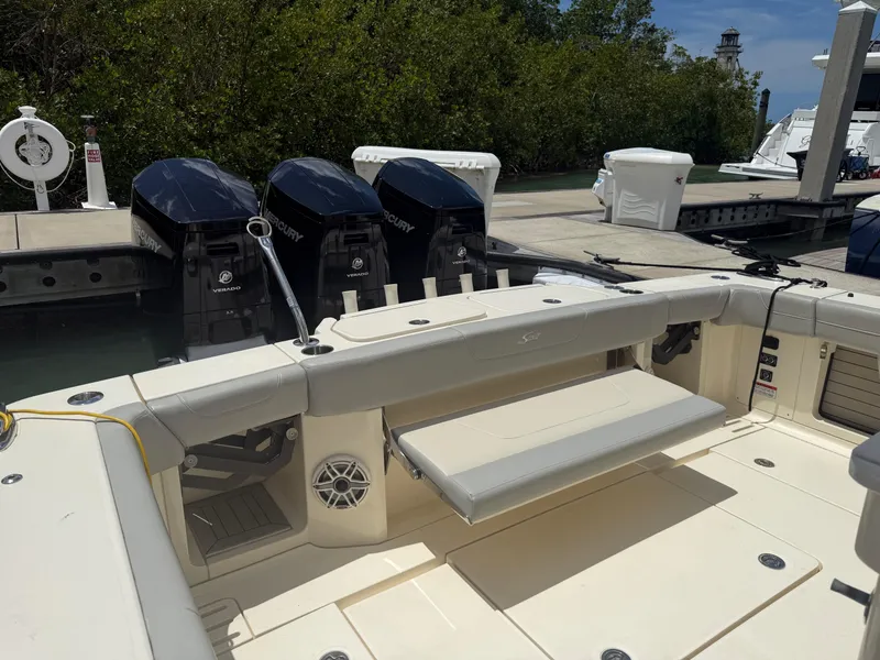 Slide: The Image of 2022 Scout 425 LXF boat with triple Mercury outboard engines docked at marina. - 9