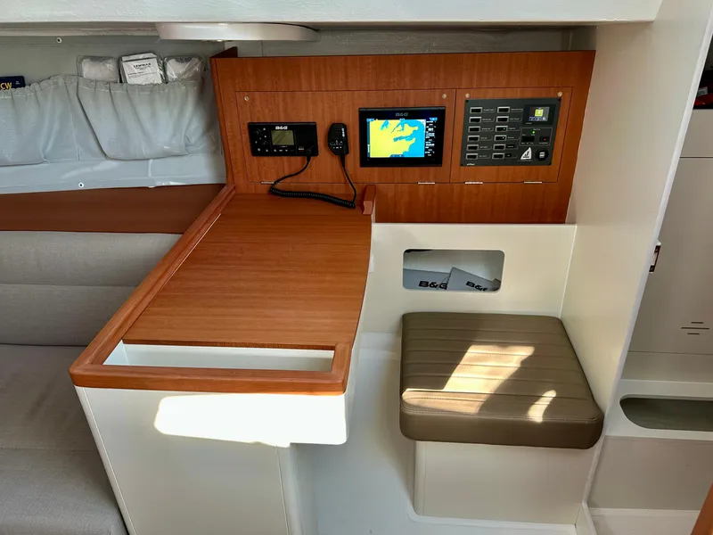 Slide: The Image of 2023 J Boats J/99 interior navigation station with control panel and seating. - 22