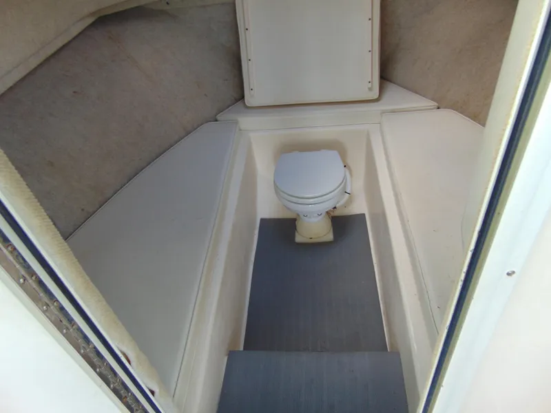 Slide: The Image of 2005 Parker 2520 Deep Vee Sport Cabin interior with marine toilet. - 10