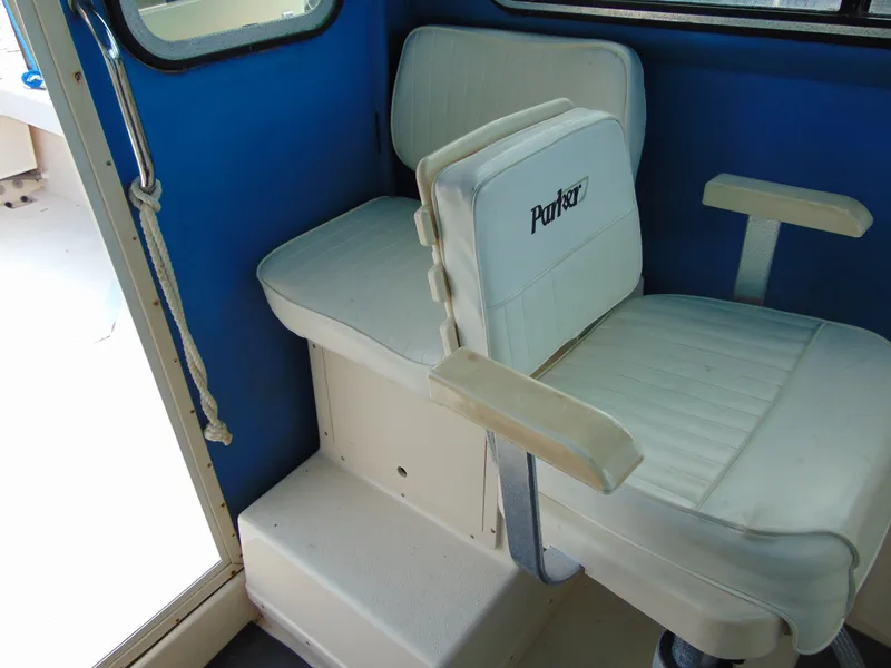 Slide: The Image of 2005 Parker 2520 Deep Vee Sport Cabin interior with white seating. - 11