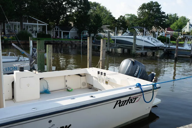 Slide: The Image of 2005 Parker 2520 Deep Vee Sport Cabin boat docked by waterfront homes. - 18