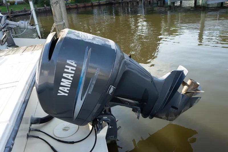 Slide: The Image of Yamaha outboard motor on 2005 Parker 2520 Deep Vee Sport Cabin boat, docked by water. - 20