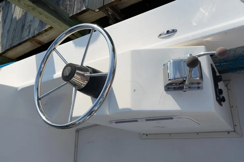 Slide: The Image of Steering wheel and controls of 2005 Parker 2520 Deep Vee Sport Cabin boat. - 22