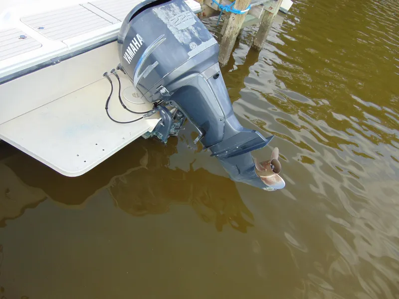Slide: The Image of Outboard motor on a 2005 Parker 2520 Deep Vee Sport Cabin boat in water. - 6