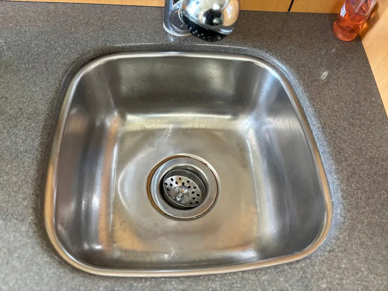 Slide: The Image of Stainless steel sink in 2004 Maxum 2900 SCR boat kitchen area. - 11