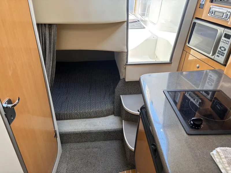 Slide: The Image of Interior of 2004 Maxum 2900 SCR boat with kitchenette and sleeping area. - 15