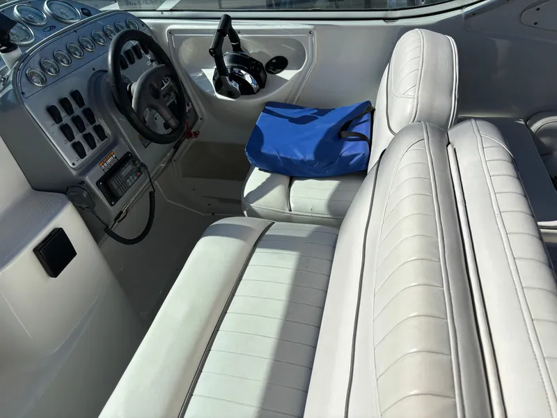 Slide: The Image of 2004 Maxum 2900 SCR boat interior with white seating and blue bag. - 2
