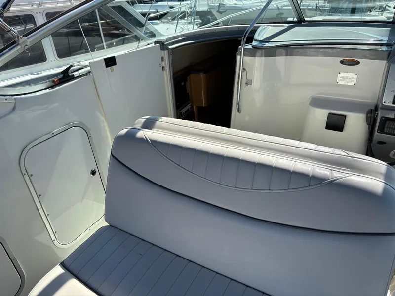 Slide: The Image of 2004 Maxum 2900 SCR boat interior with seating and cabin entrance. - 4