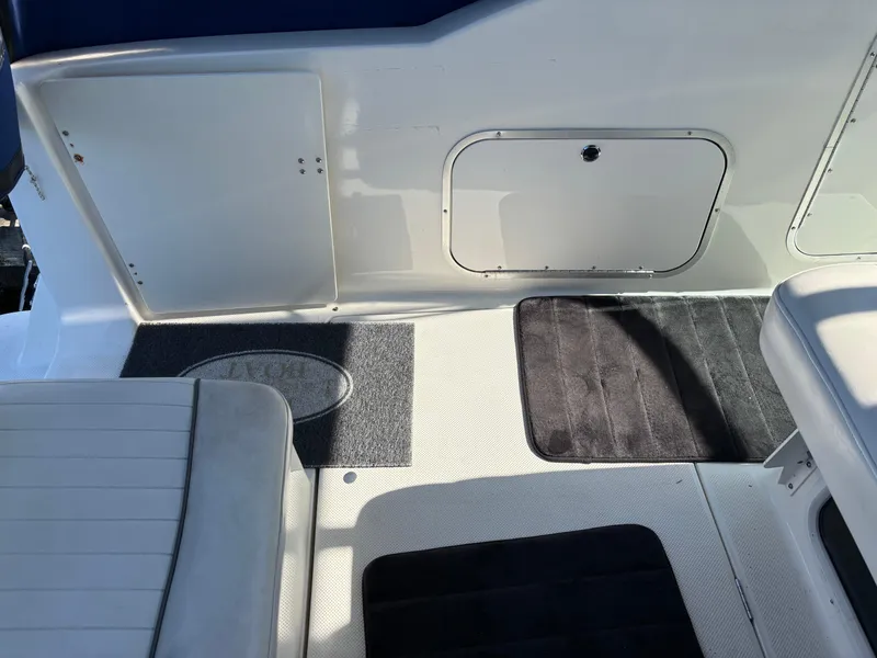 Slide: The Image of 2004 Maxum 2900 SCR boat interior with seating and storage compartments. - 6