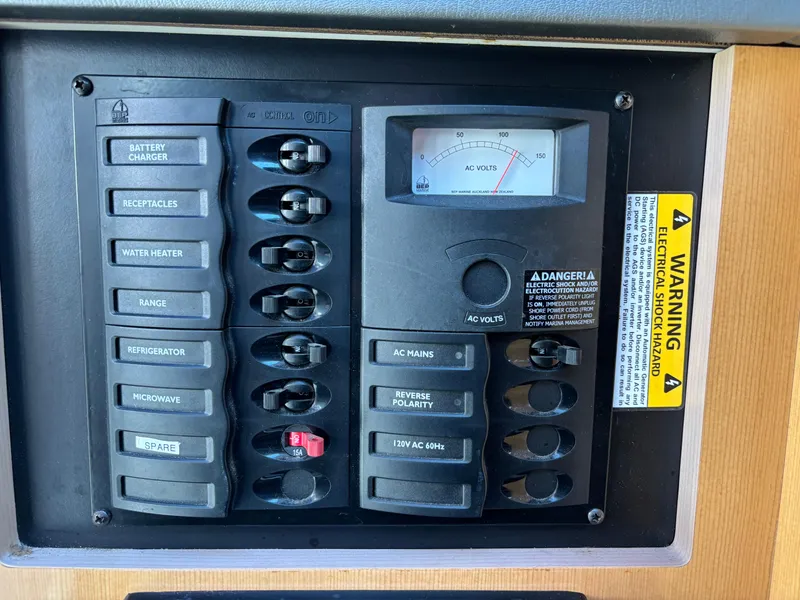 Slide: The Image of Electrical control panel of 2004 Maxum 2900 SCR boat with various switches and warning label. - 7