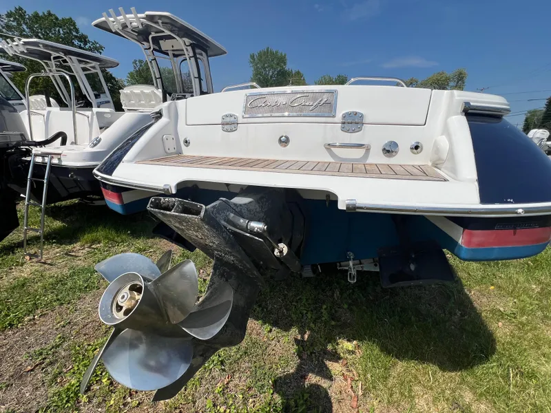 Slide: The Image of 2004 Chris-Craft Corsair 25 boat rear view with propeller, displayed outdoors. - 4