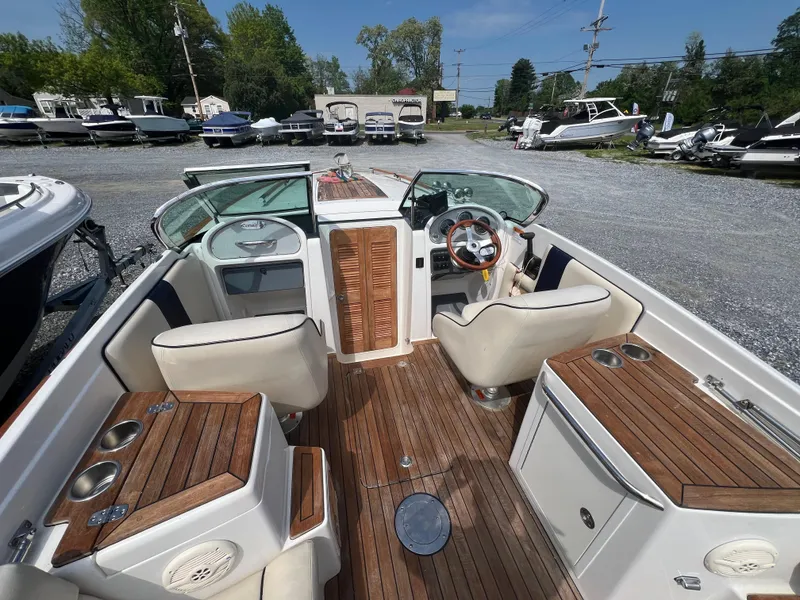Slide: The Image of 2004 Chris-Craft Corsair 25 boat interior with wood accents and seating. - 5
