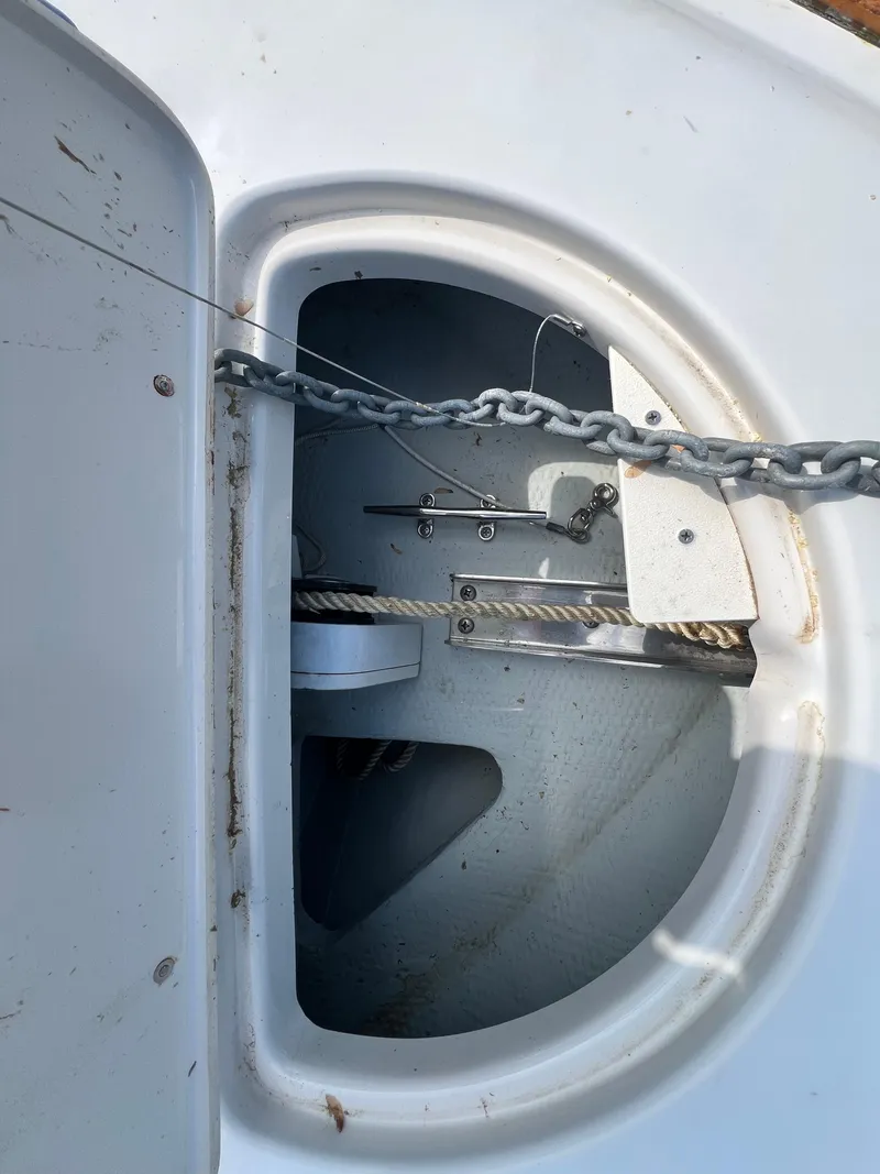 Slide: The Image of Anchor compartment of 2004 Chris-Craft Corsair 25 boat, featuring chain and storage area. - 7