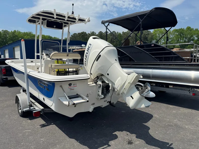 Slide: The Image of 2021 Carolina Skiff 21 LS boat with Suzuki outboard motor on trailer. - 0
