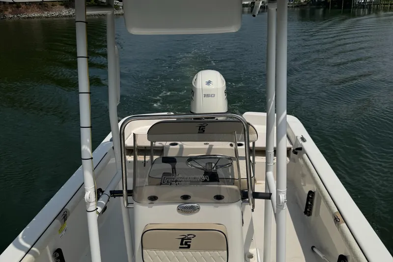 Slide: The Image of 2021 Carolina Skiff 21 LS boat interior with steering console on calm water. - 10