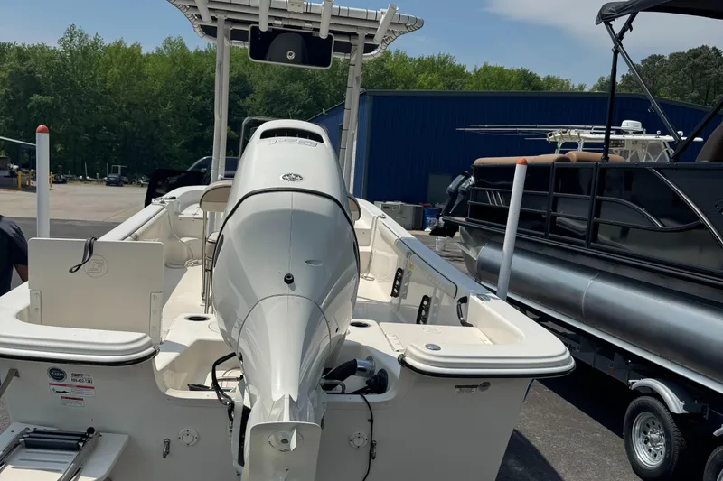 Slide: The Image of 2021 Carolina Skiff 21 LS boat with outboard motor, parked outdoors. - 5