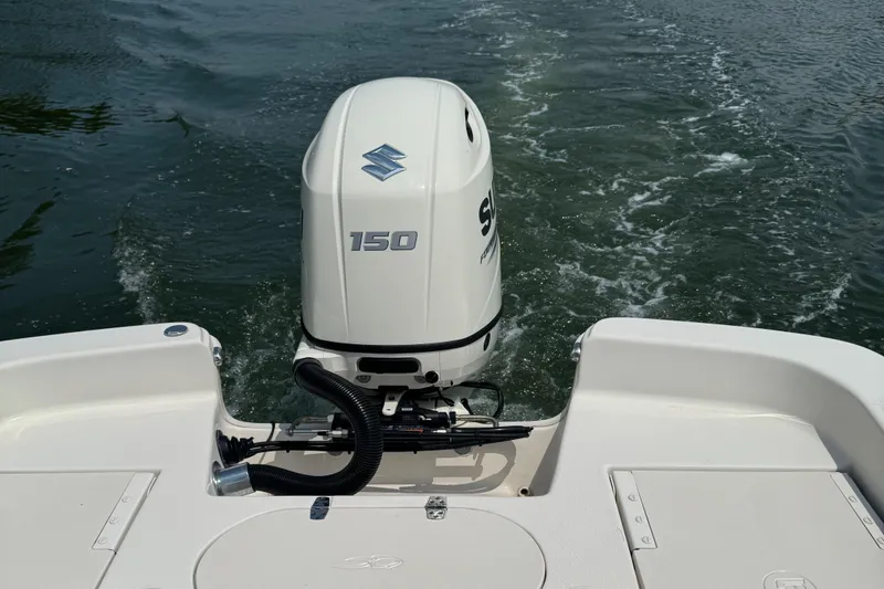 Slide: The Image of 2021 Carolina Skiff 21 LS boat with Suzuki 150 outboard motor on water. - 7